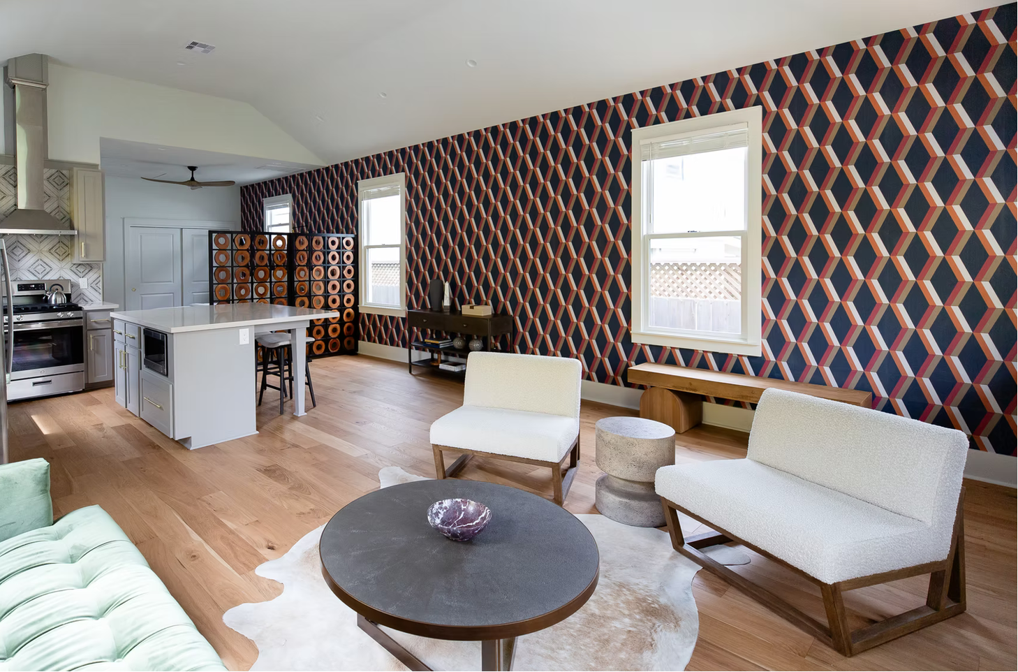 Modern living room with patterned wallpaper, furniture, and decor.